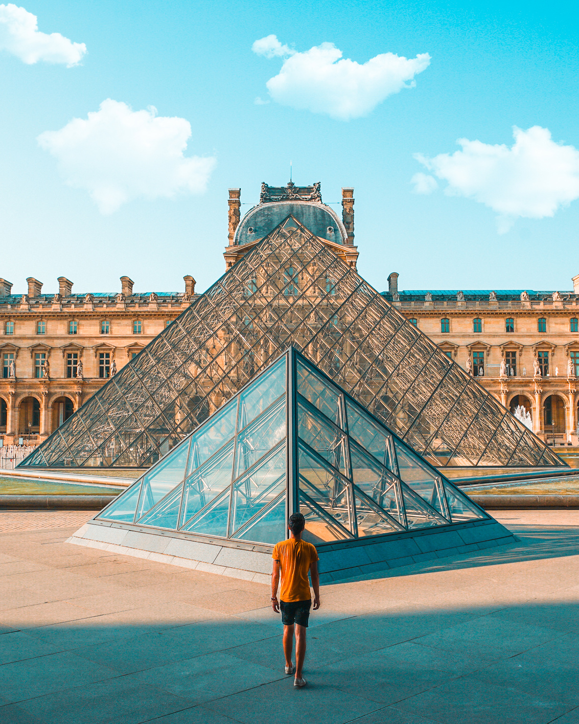 Man Standing in Front of Louvre Museum of Paris